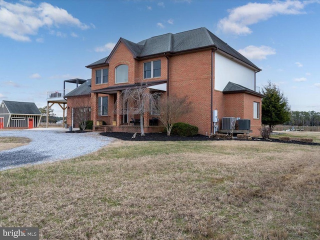 view of front facade featuring cooling unit and a front yard