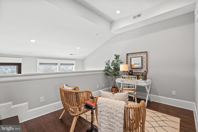 living area with wood-type flooring and lofted ceiling