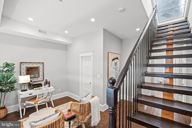 stairway with hardwood / wood-style floors