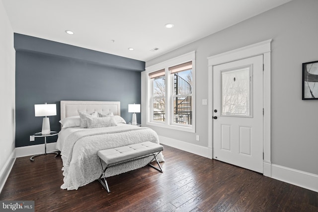 bedroom with dark wood-type flooring