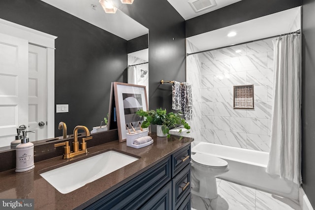 full bathroom featuring shower / bath combo, vanity, and toilet