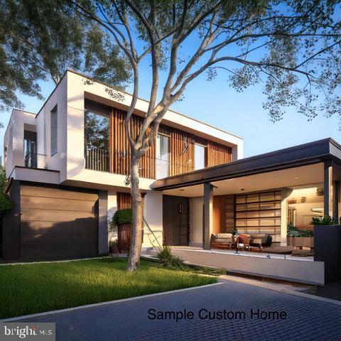 rear view of property with a garage and a balcony