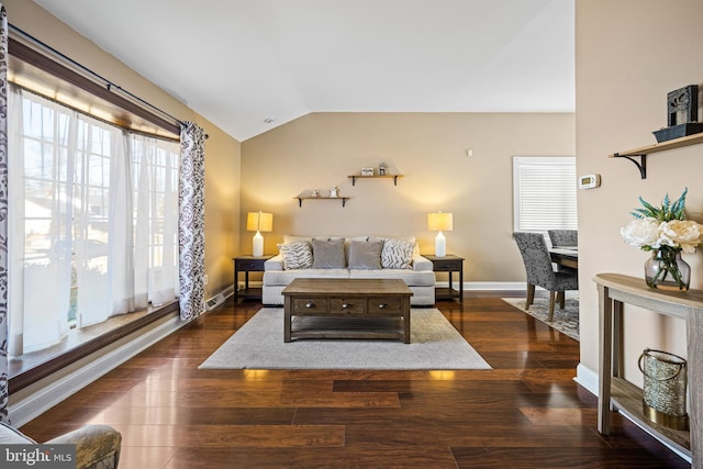 living room with dark wood-type flooring and lofted ceiling