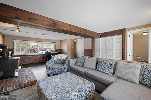 living room featuring dark hardwood / wood-style floors and beam ceiling