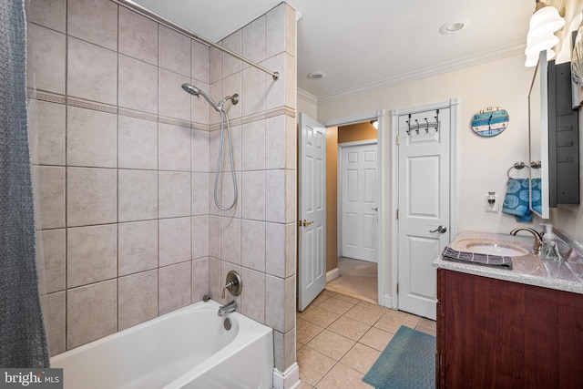 bathroom with ornamental molding, tile patterned floors, tiled shower / bath, and vanity