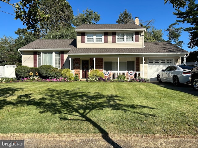 view of front of home with a porch, a garage, and a front yard