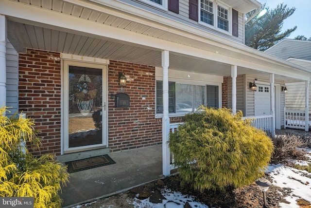 view of exterior entry featuring a porch