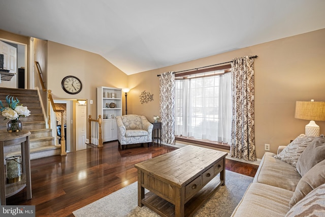 living room featuring vaulted ceiling and dark hardwood / wood-style floors