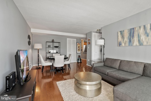 living room featuring hardwood / wood-style floors and a textured ceiling