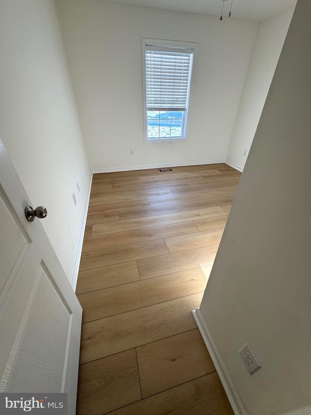 spare room with light wood-type flooring