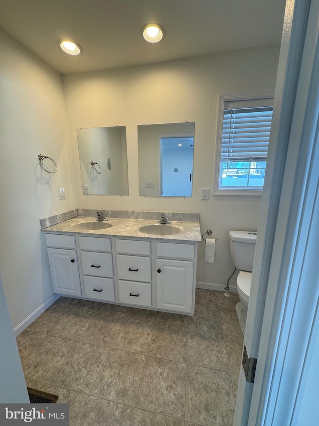 bathroom featuring vanity and toilet