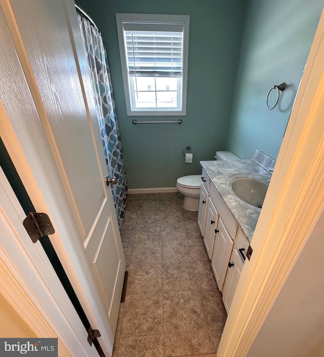 bathroom featuring tile patterned flooring, vanity, and toilet