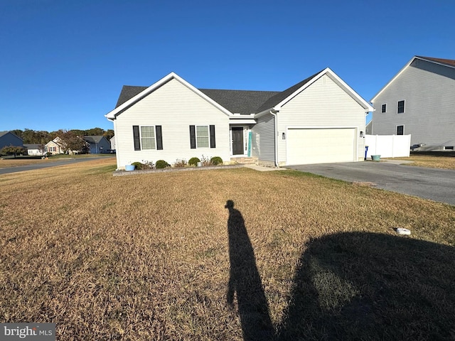 view of front of home with a front yard and a garage