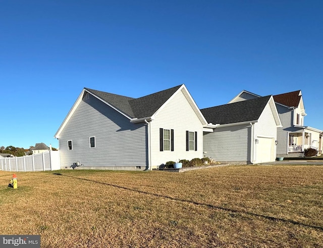 view of home's exterior featuring a lawn and a garage