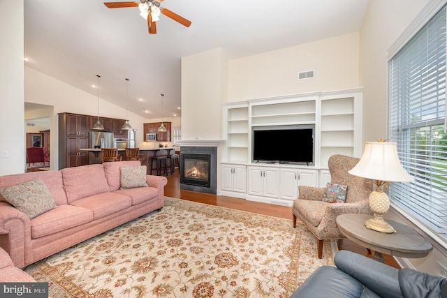 226 Loyal Dr, Mechanicsburg, PA 17050 - living room featuring lofted ceiling, wood finished floors, ceiling fan, and a glass covered fireplace