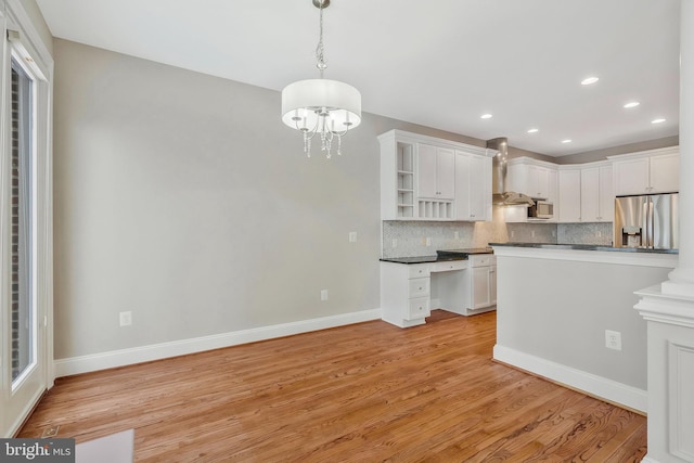 kitchen with backsplash, appliances with stainless steel finishes, decorative light fixtures, and white cabinets