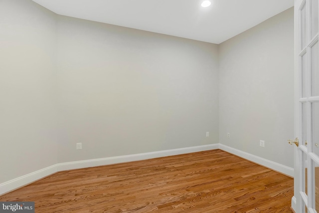 unfurnished room with hardwood / wood-style floors