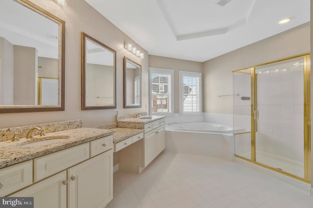 bathroom with vanity, shower with separate bathtub, and a tray ceiling