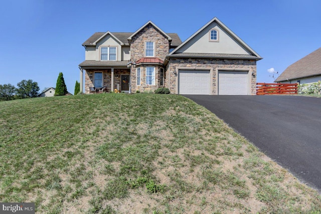 view of front of property with a garage and a front lawn