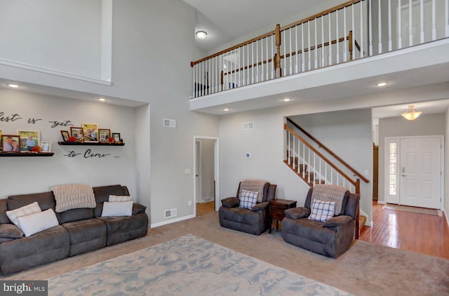 carpeted living room featuring a high ceiling