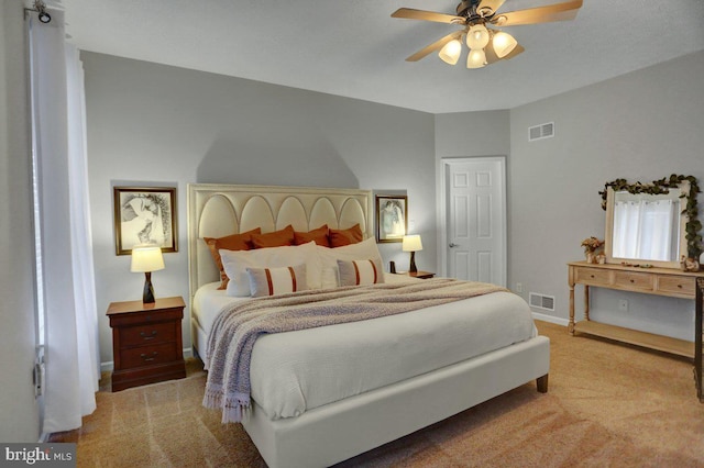 bedroom with ceiling fan and light colored carpet