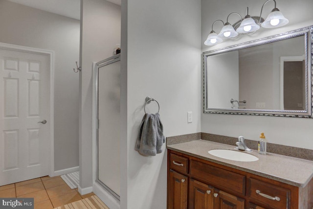 bathroom featuring tile patterned flooring, vanity, and walk in shower