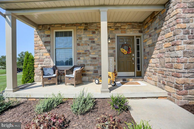 view of exterior entry with a porch