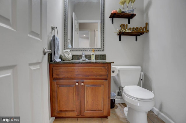 bathroom featuring tile patterned floors, vanity, and toilet