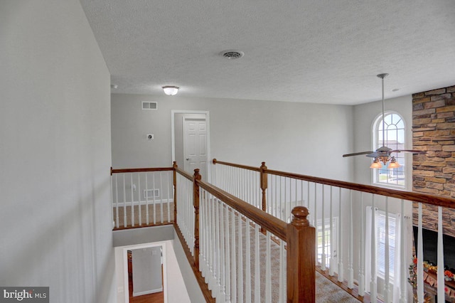 hall with a textured ceiling