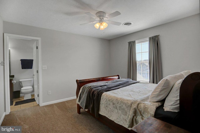 carpeted bedroom featuring ceiling fan, a textured ceiling, and connected bathroom