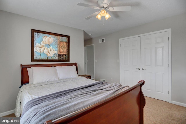 carpeted bedroom featuring a closet and ceiling fan