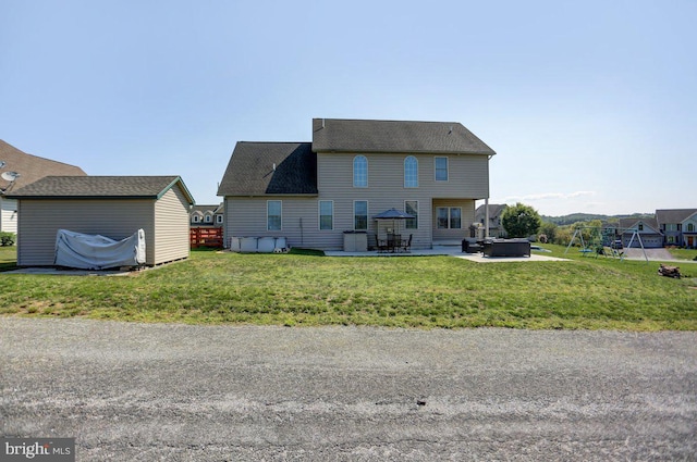 rear view of house with a patio area and a yard