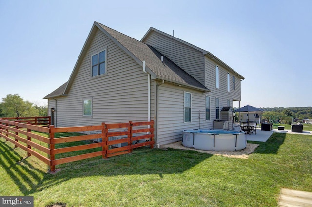 view of property exterior with a gazebo, a patio area, and a yard