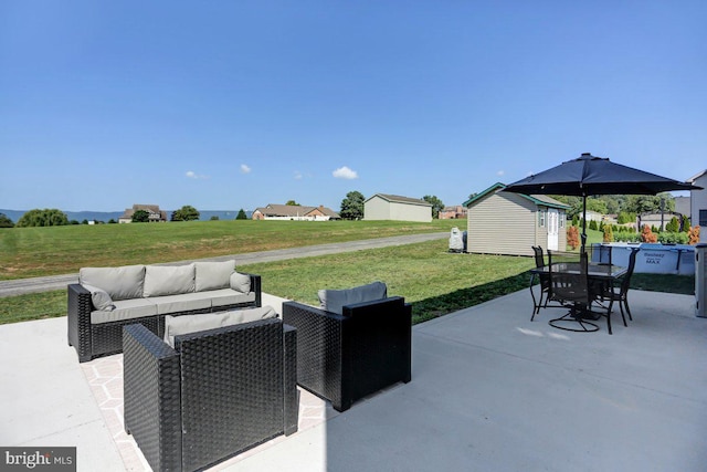 view of patio featuring a shed and an outdoor hangout area