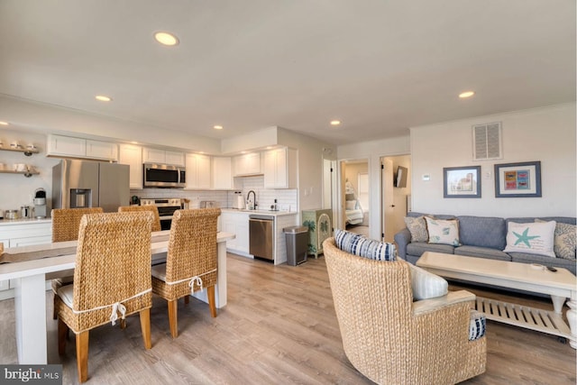 interior space with light hardwood / wood-style floors and sink