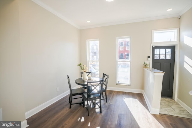 dining area featuring dark wood-type flooring and ornamental molding