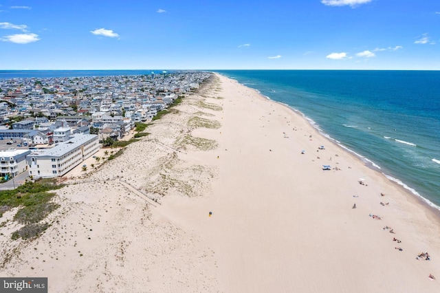 bird's eye view featuring a water view and a view of the beach