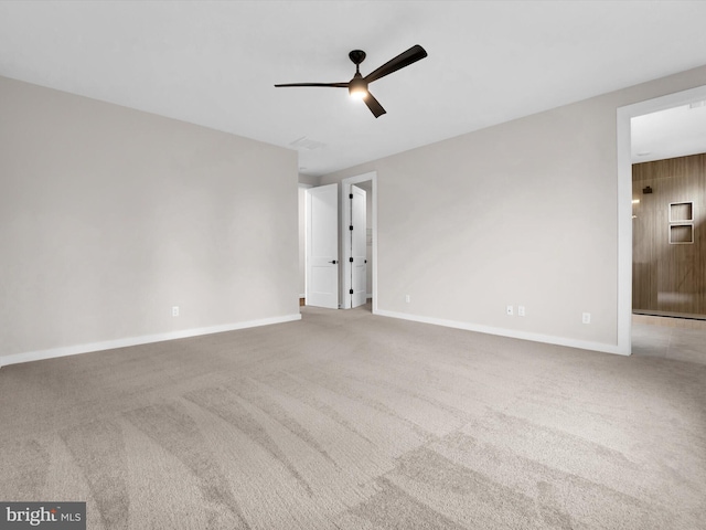 unfurnished room with ceiling fan and carpet