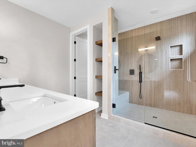 bathroom with tile patterned flooring, vanity, and a shower with door