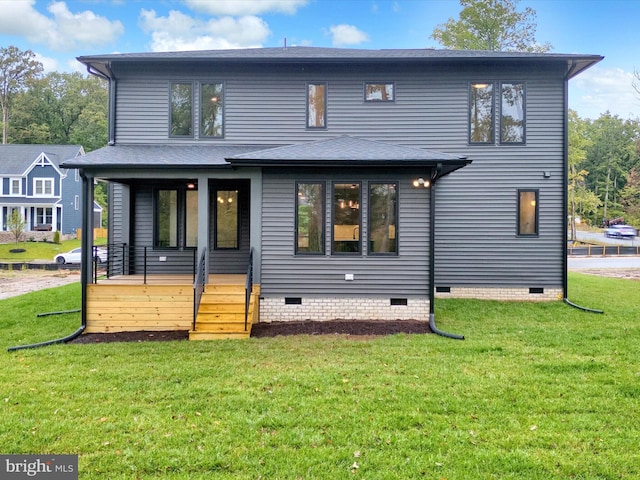 rear view of property featuring a lawn and a porch