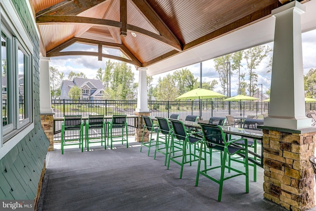 view of patio / terrace with outdoor dry bar, a gazebo, and fence
