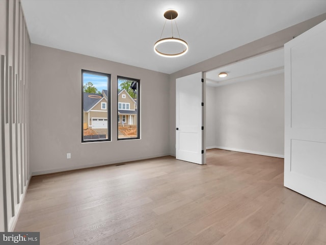 spare room featuring light wood-type flooring