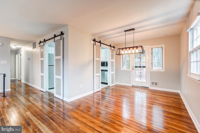 interior space with hardwood / wood-style flooring and a barn door