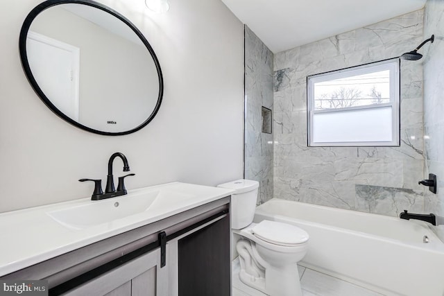 full bathroom with toilet, vanity, and tiled shower / bath