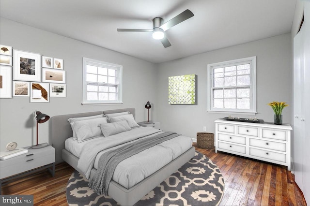 bedroom with ceiling fan and dark hardwood / wood-style floors