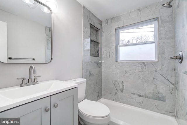 bathroom with a shower, vanity, and toilet