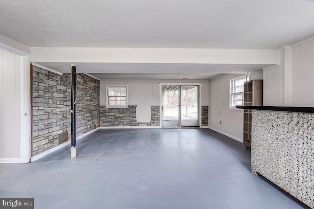 unfurnished living room with concrete floors