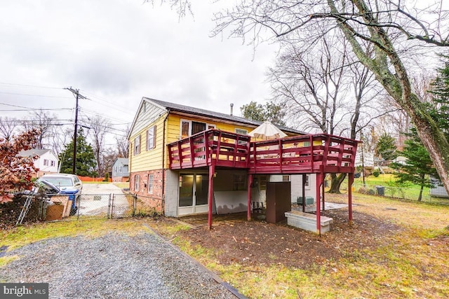 back of property featuring cooling unit and a wooden deck