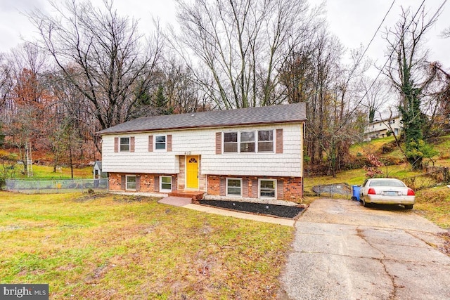 split foyer home with a front lawn