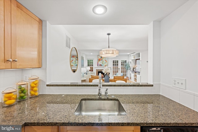 2518 S Walter Reed Dr Unit B, Arlington, VA 22206 - kitchen with a sink, backsplash, dark stone countertops, and open floor plan